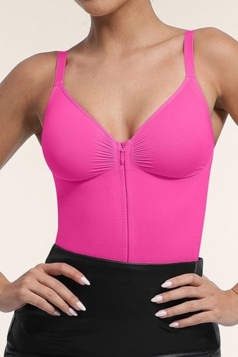 Person wearing a pink bodysuit against a neutral background