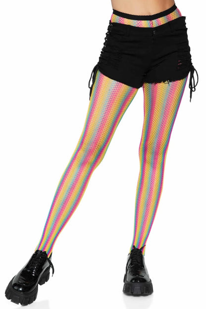 A model's lower body wearing rainbow striped fishnet tights, black lace-up shorts, and black platform shoes against a plain white background.