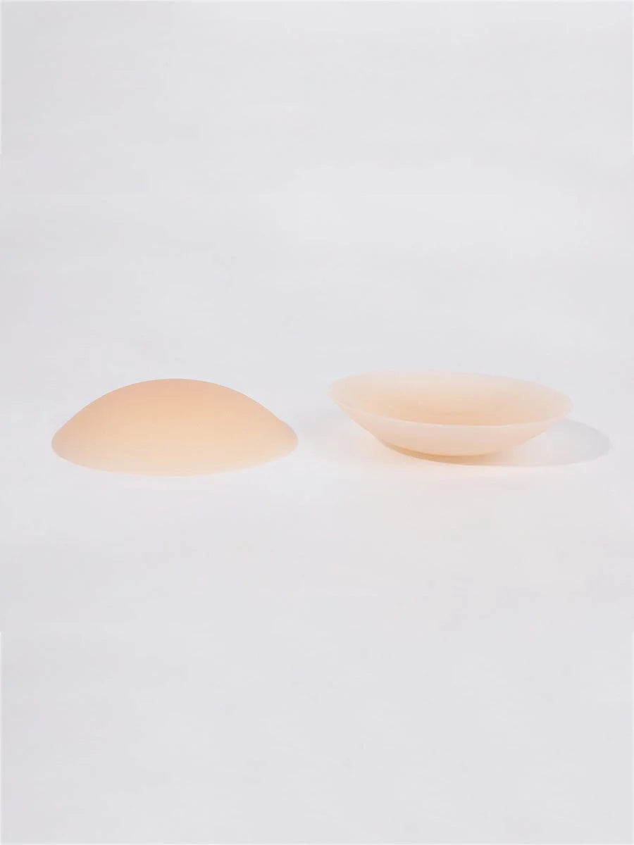 Two beige-colored bowls on a white background