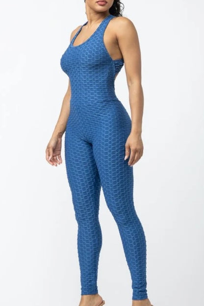 Woman wearing a blue patterned jumpsuit on a white background