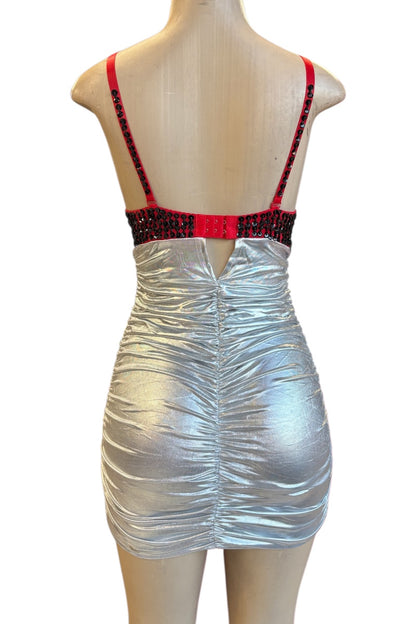 Silver dress with red and black straps on a mannequin against a white background