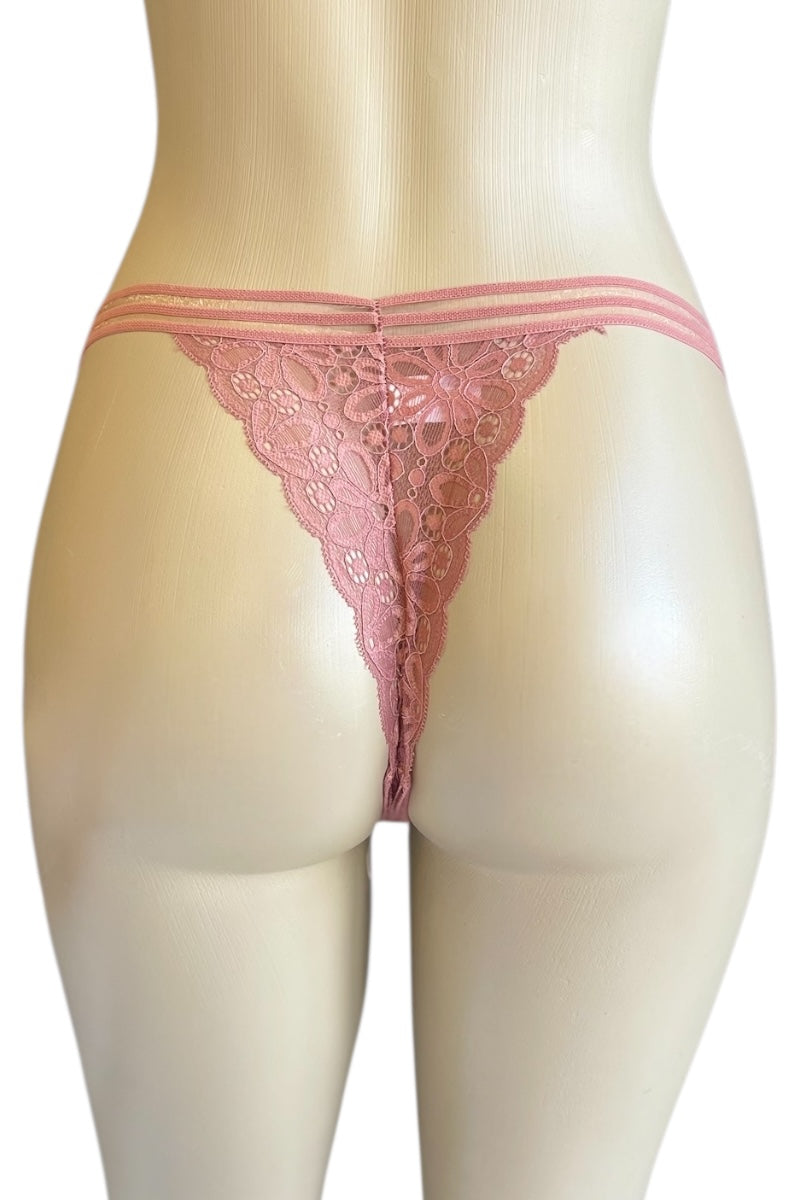 Pink lace thong on a mannequin against a white background