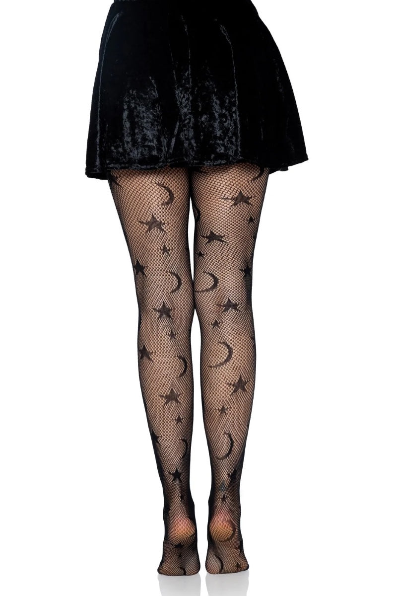 Black fishnet tights with a star and crescent moon pattern, shown on a model from the waist down wearing a black skirt, against a plain white background.