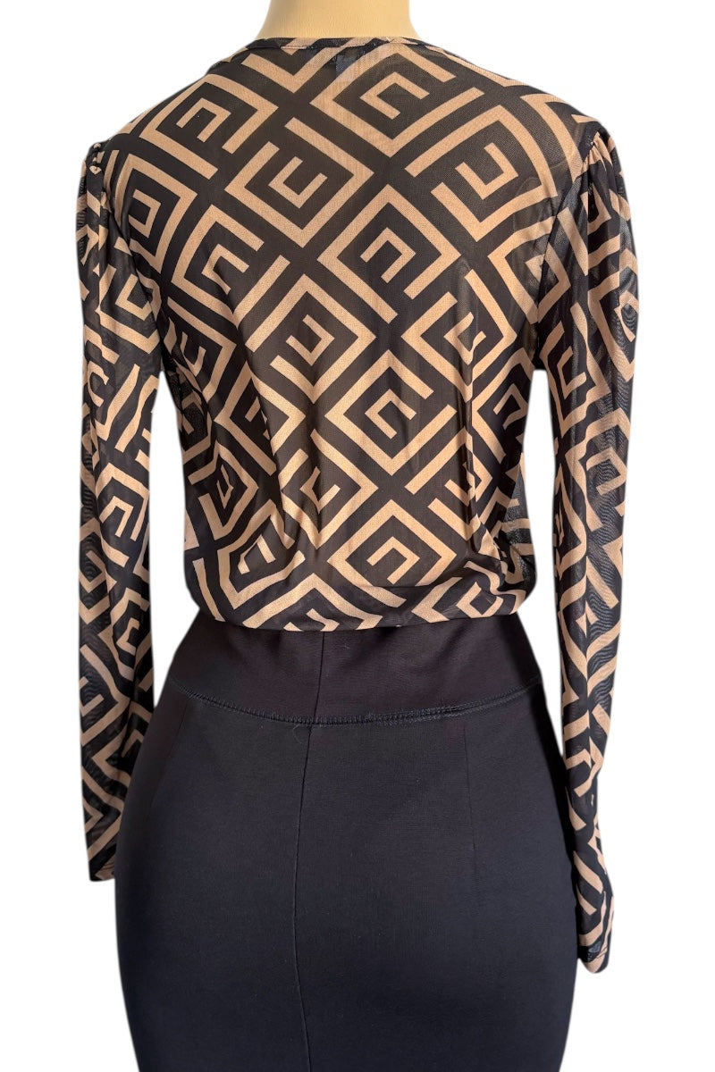 Patterned long-sleeve top on a mannequin with a plain background