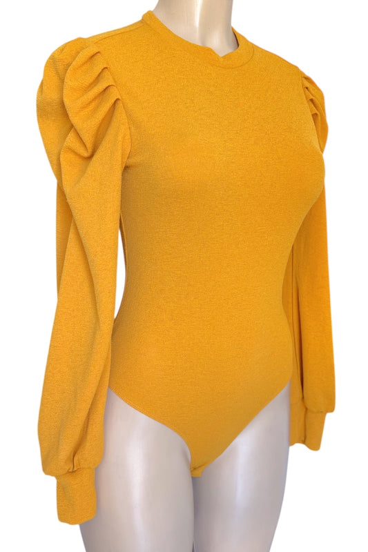 Mustard yellow top with puff sleeves on a mannequin against a white background