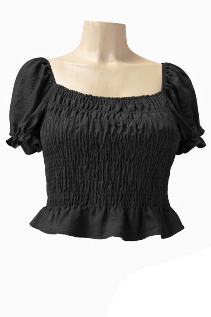 Black smocked top on a mannequin against a white background