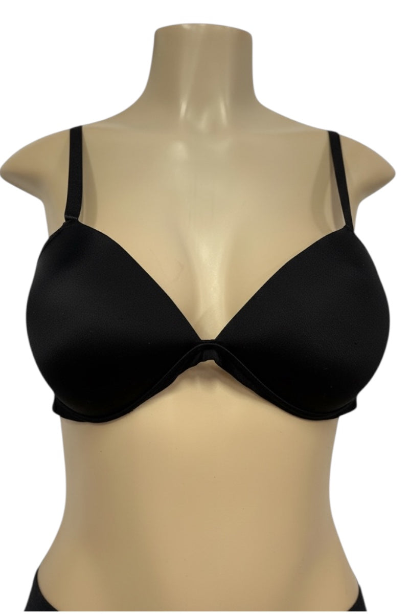 Black bra on a beige mannequin against a white background