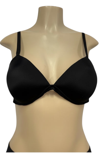 Black bra on a beige mannequin against a white background