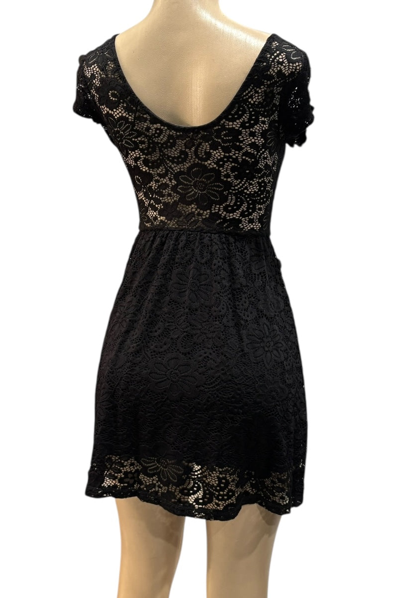 Black lace dress on a mannequin against a white background