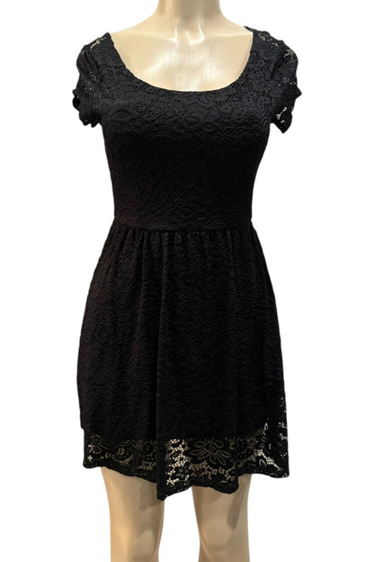 Black lace dress on a mannequin against a white background