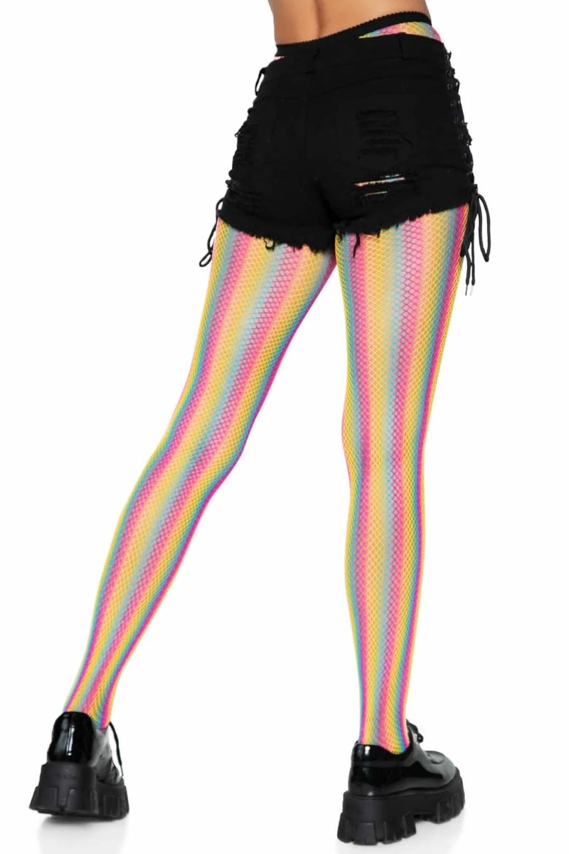 A person shown from the waist down wearing black distressed shorts and rainbow-striped fishnet tights with black platform shoes, photographed against a plain white background.