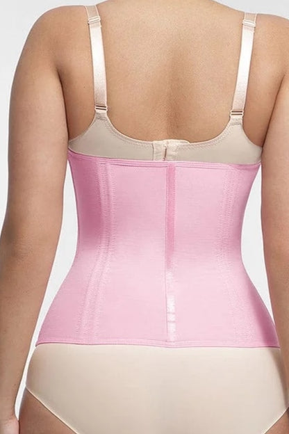 Pink waist trainer worn by a person on a plain background