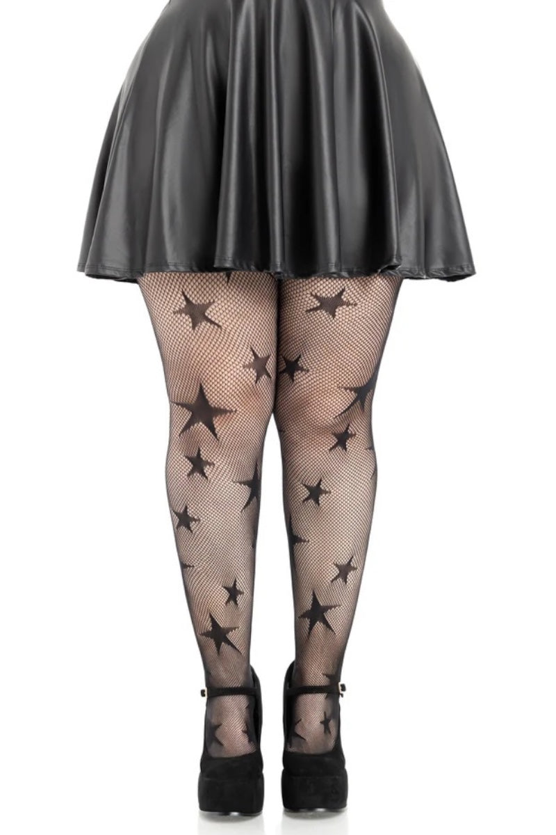 Black star-patterned fishnet tights worn by a model, paired with a black faux-leather mini skirt and black platform Mary Jane heels, shown from the waist down on a white background.