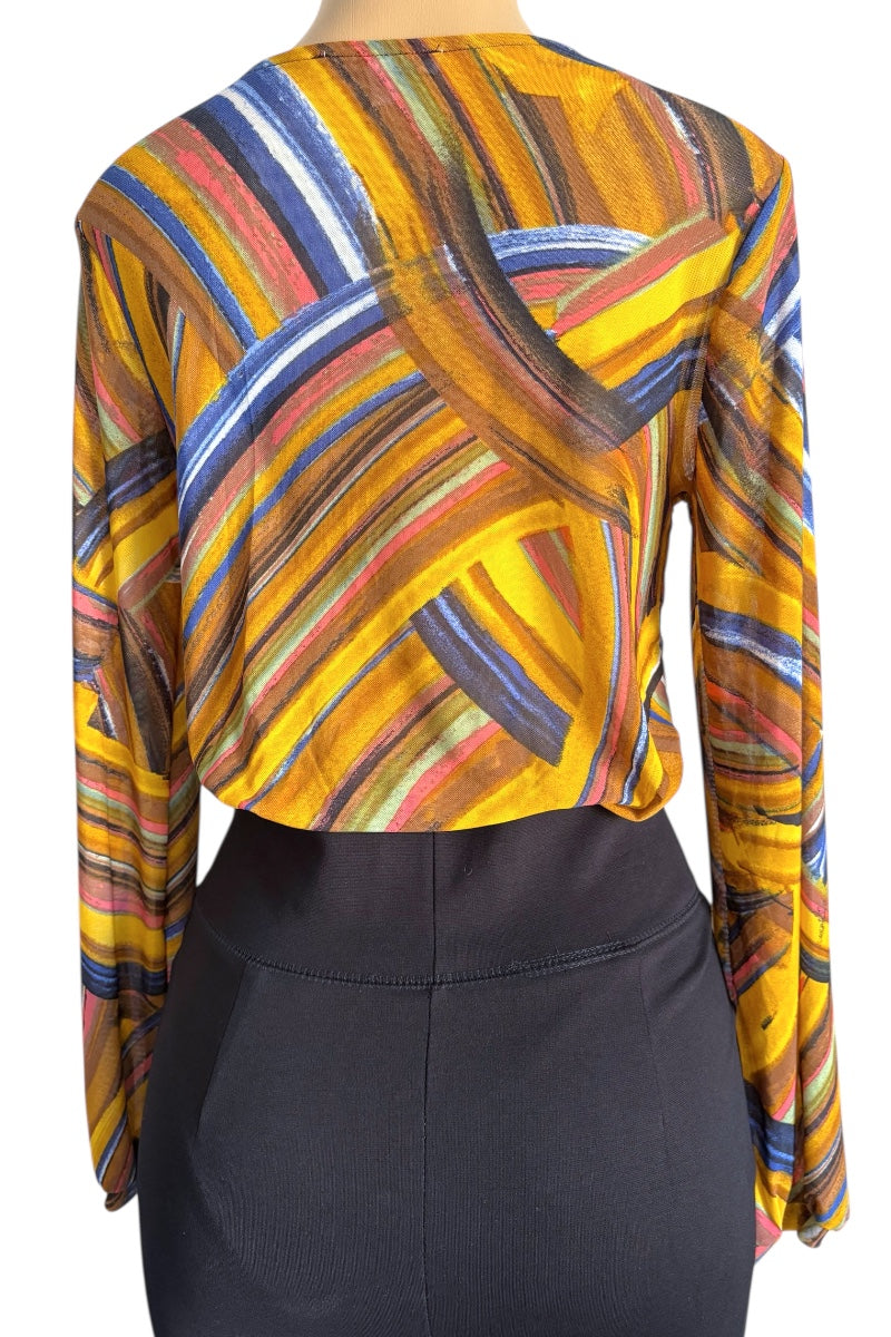 Colorful abstract patterned top worn by a mannequin, with a plain background