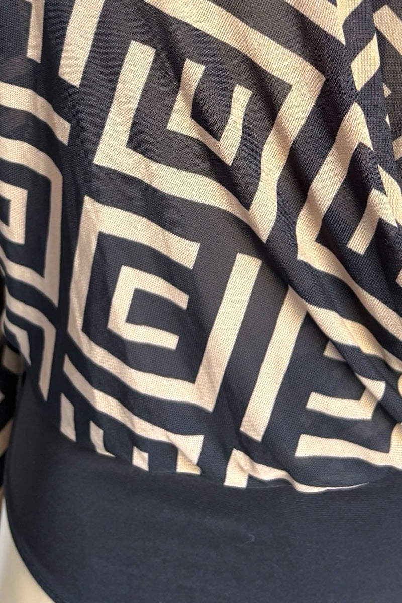 Close-up of a dark fabric with a beige geometric pattern