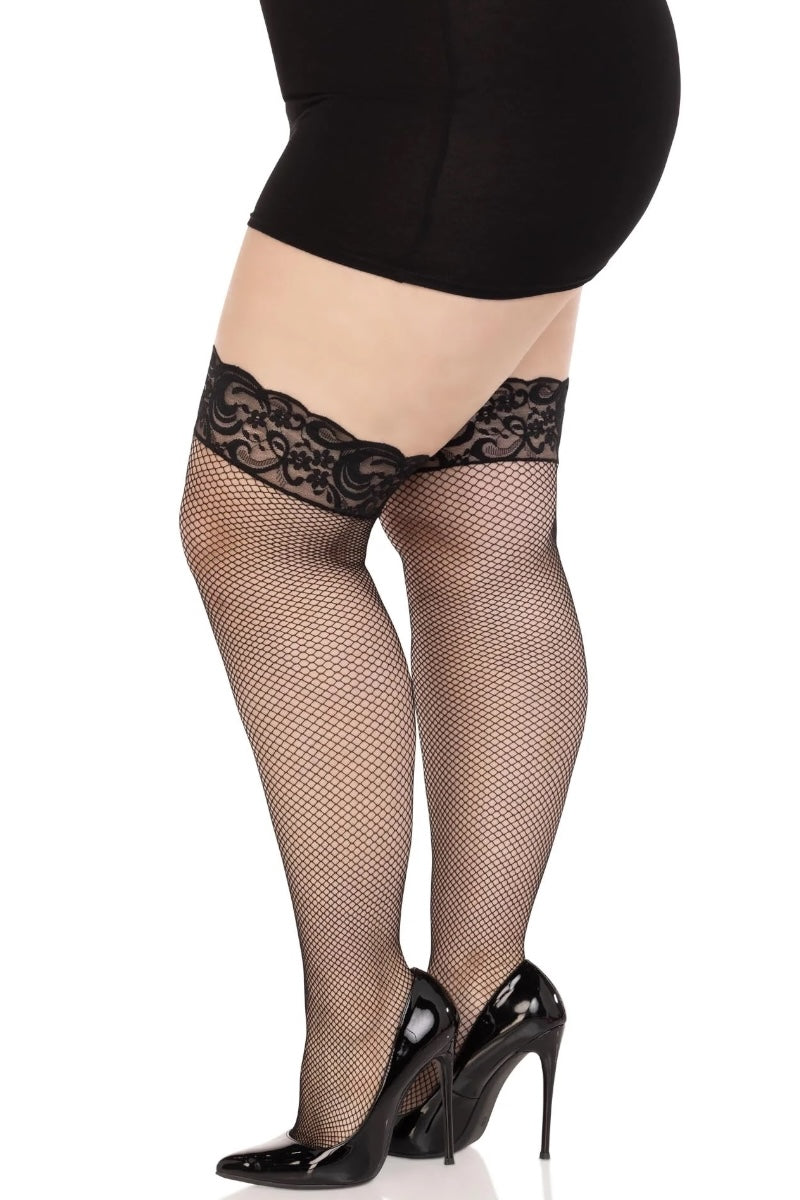 Black fishnet stockings with lace top worn by a person on a white background