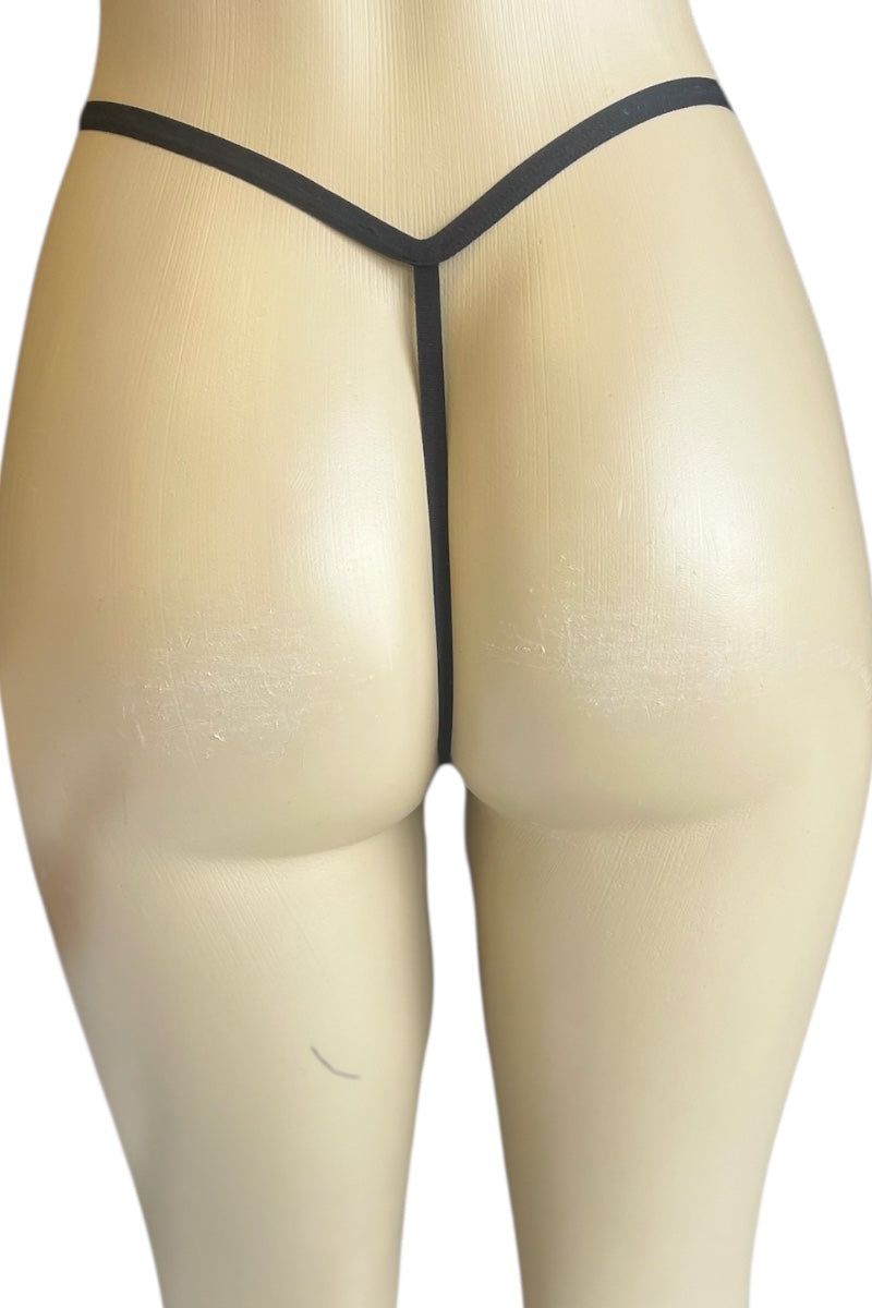 Black thong on a beige mannequin against a white background