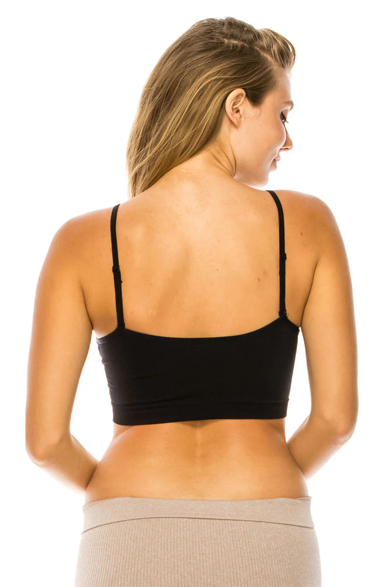 Woman wearing a black bralette on a white background