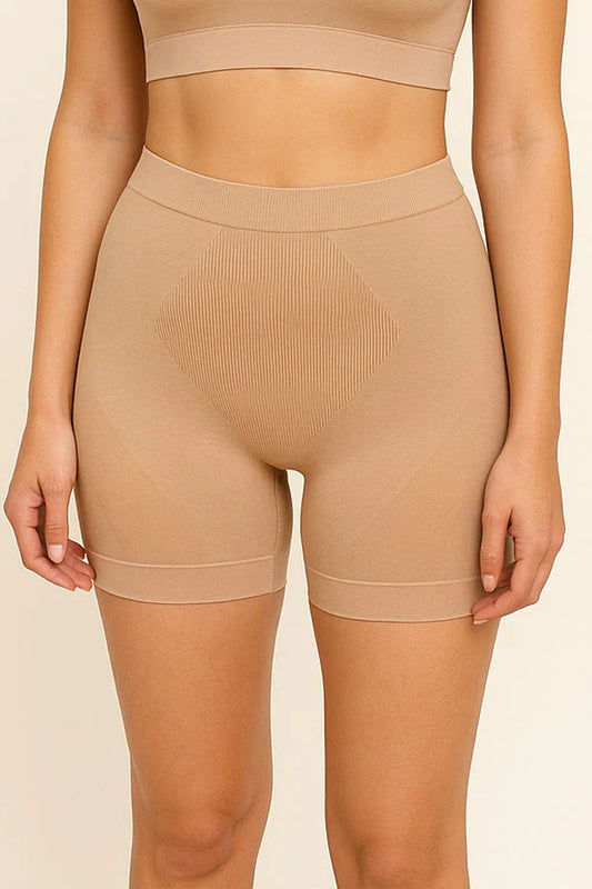 Beige shapewear shorts worn by a person on a beige background