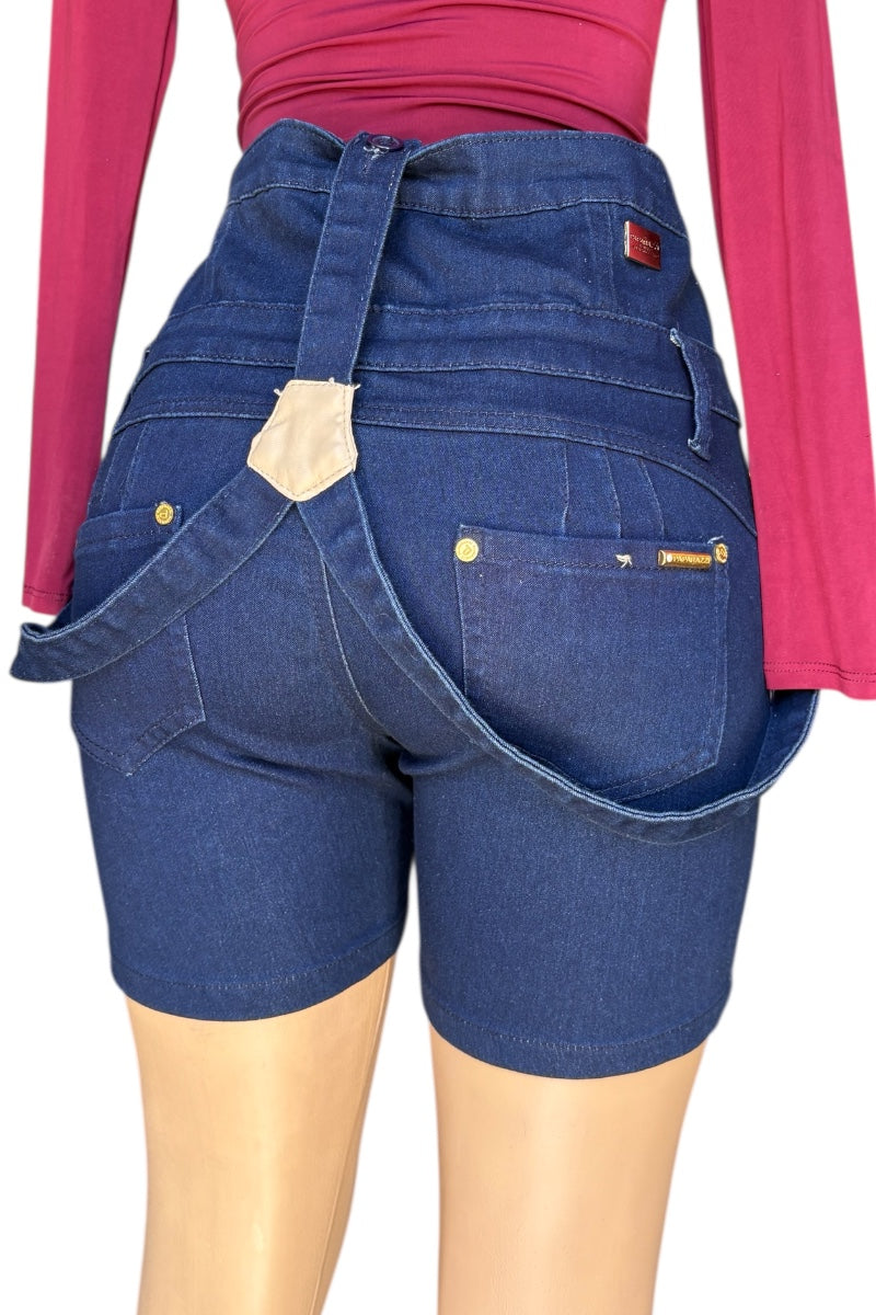 Blue denim overalls worn by a person with a red shirt underneath on a white background