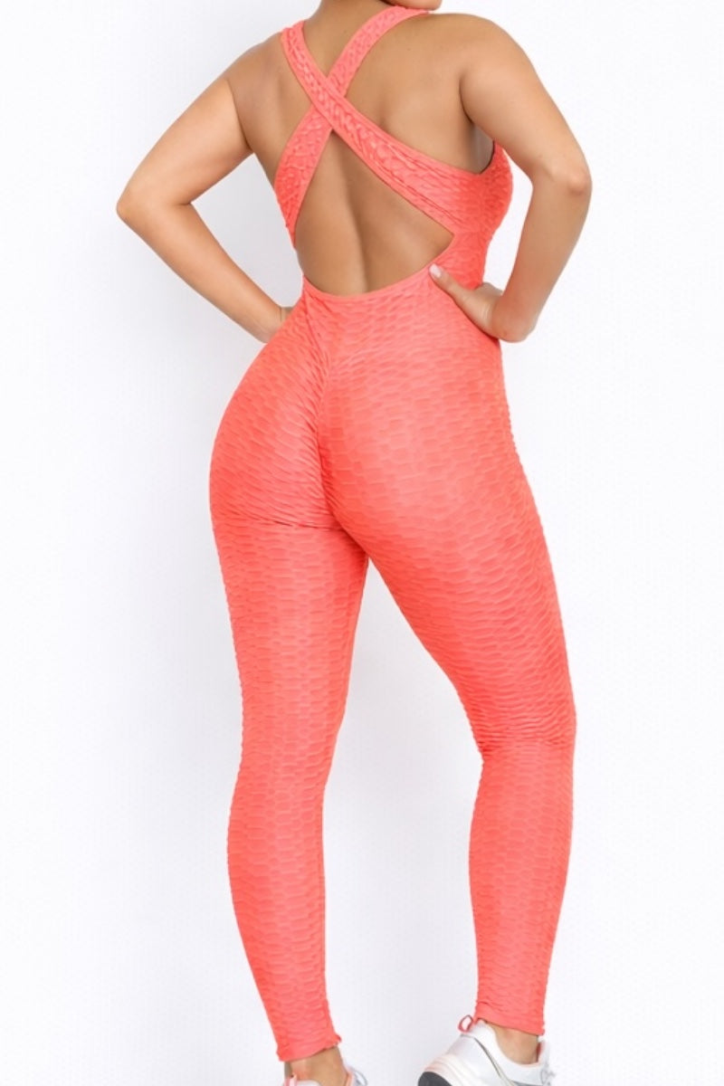 Coral jumpsuit worn by a model on a white background