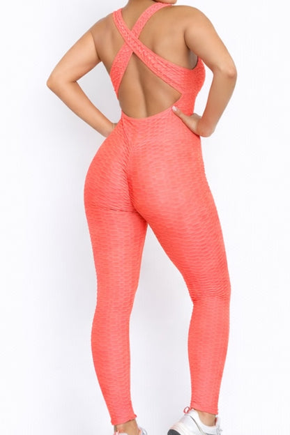 Coral jumpsuit worn by a model on a white background