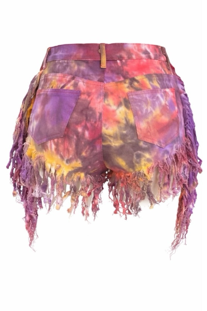 Colorful tie-dye shorts with fringe on a white background