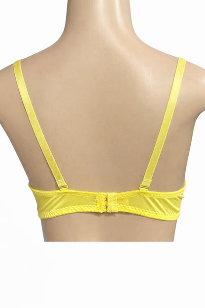 Yellow bra on a mannequin with a white background