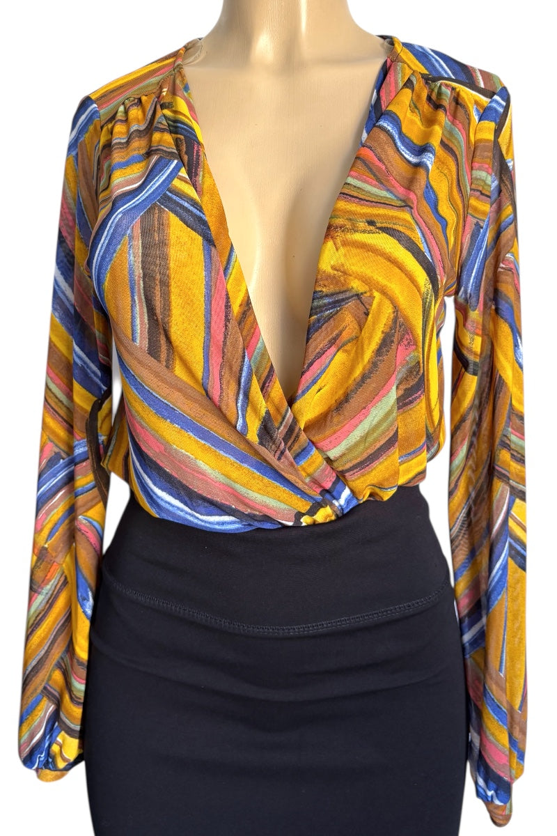 Colorful patterned blouse on a mannequin with a black skirt underneath
