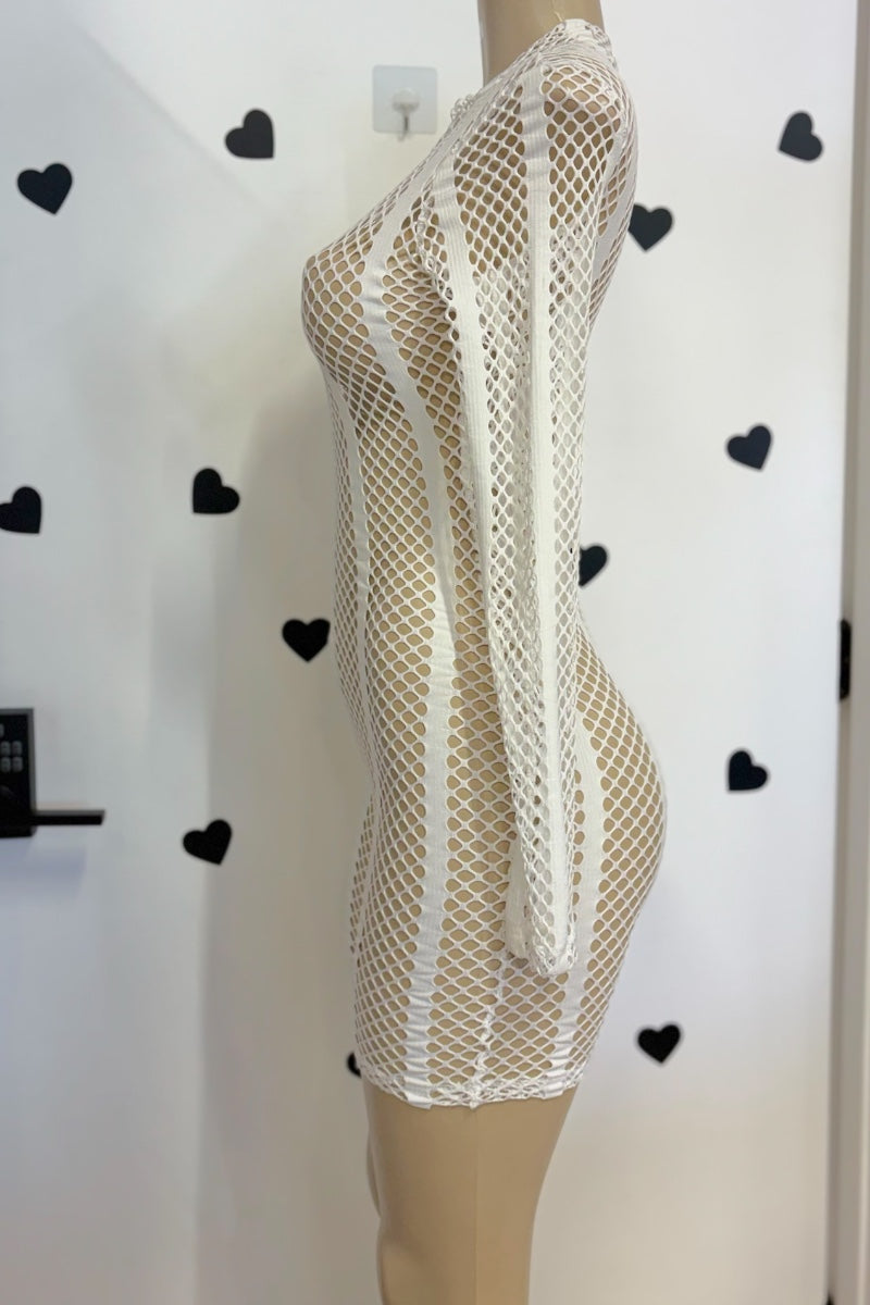A white fishnet mesh long-sleeve mini romper displayed on a beige mannequin torso against a white wall with black heart decals.