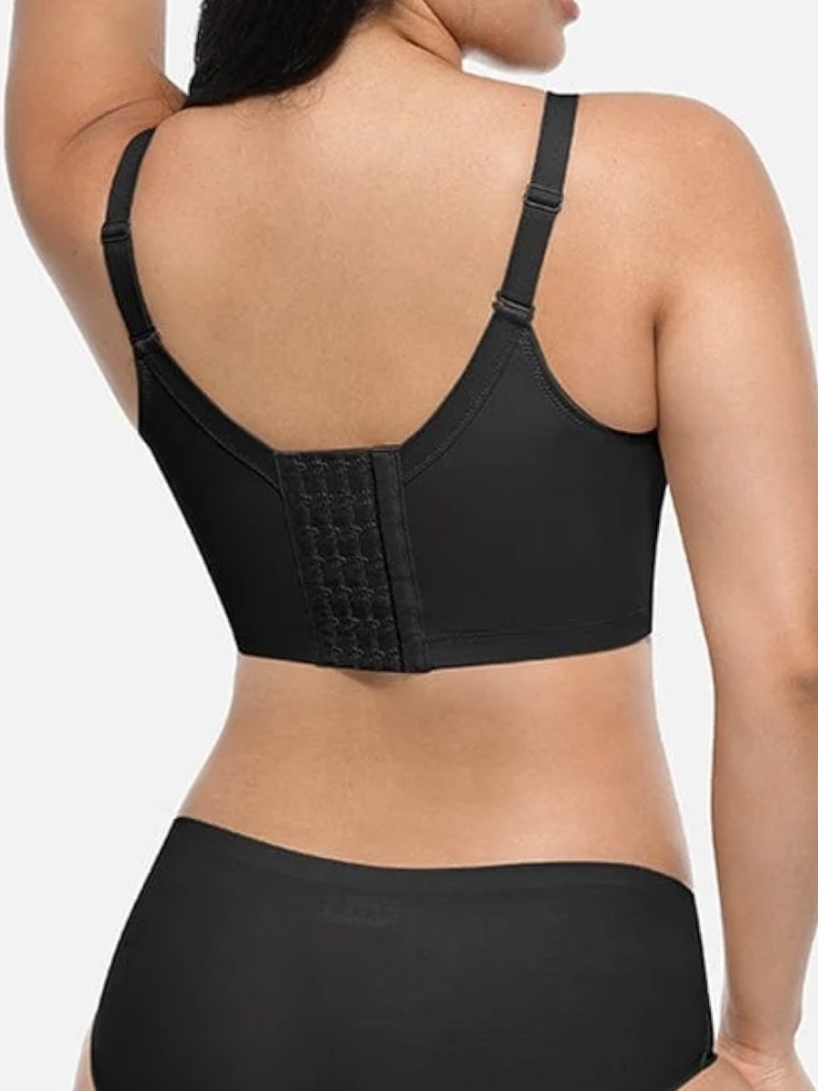 Black bra worn by a person on a white background