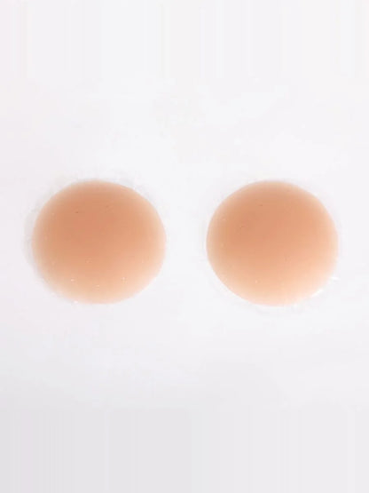 Two tan circular pasties on a white background