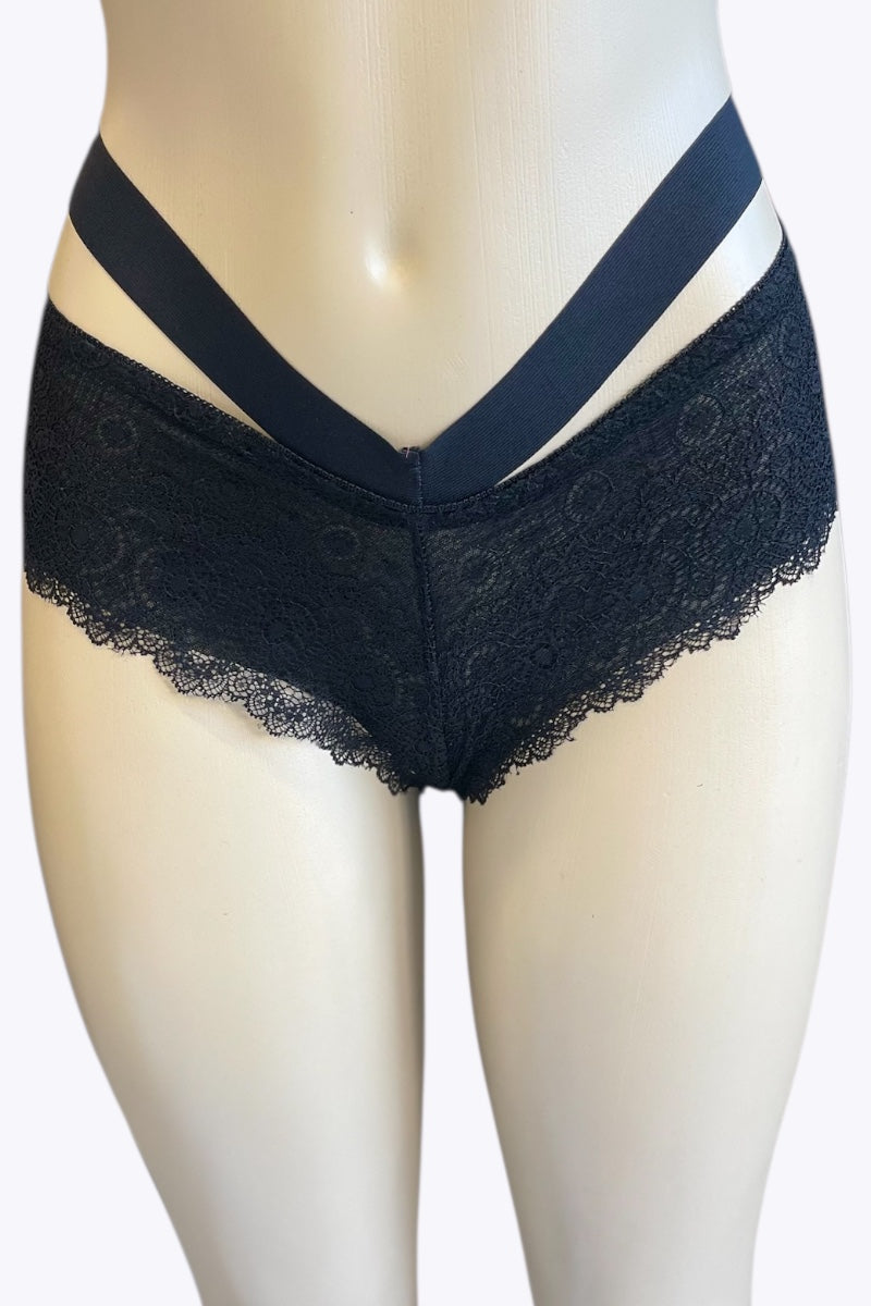 Black lace underwear on a mannequin against a white background