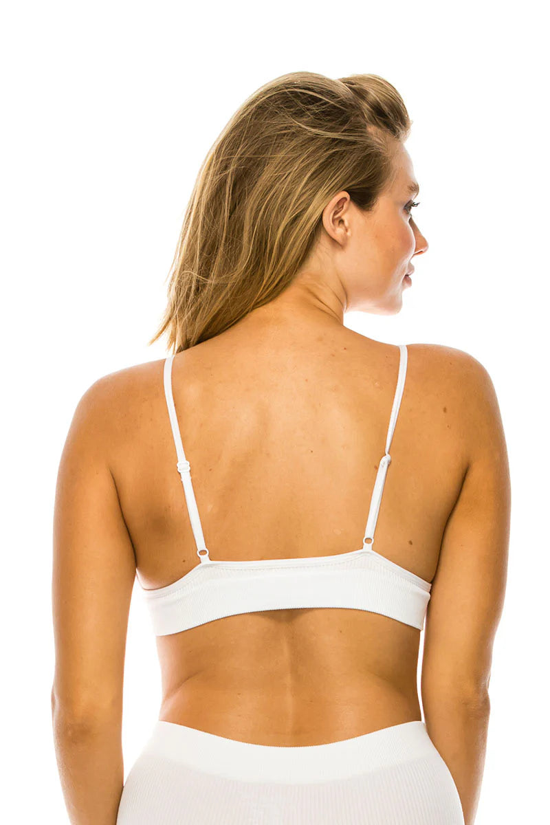 Woman wearing a white bikini top on a white background