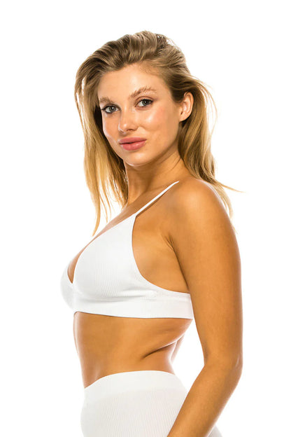 Woman wearing a white bikini top on a white background
