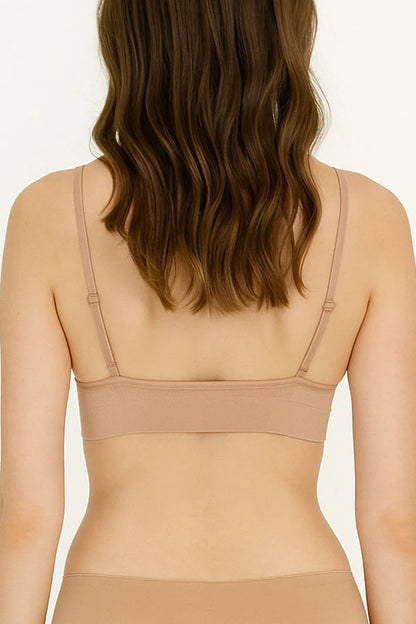 Beige bra worn by a model on a plain background