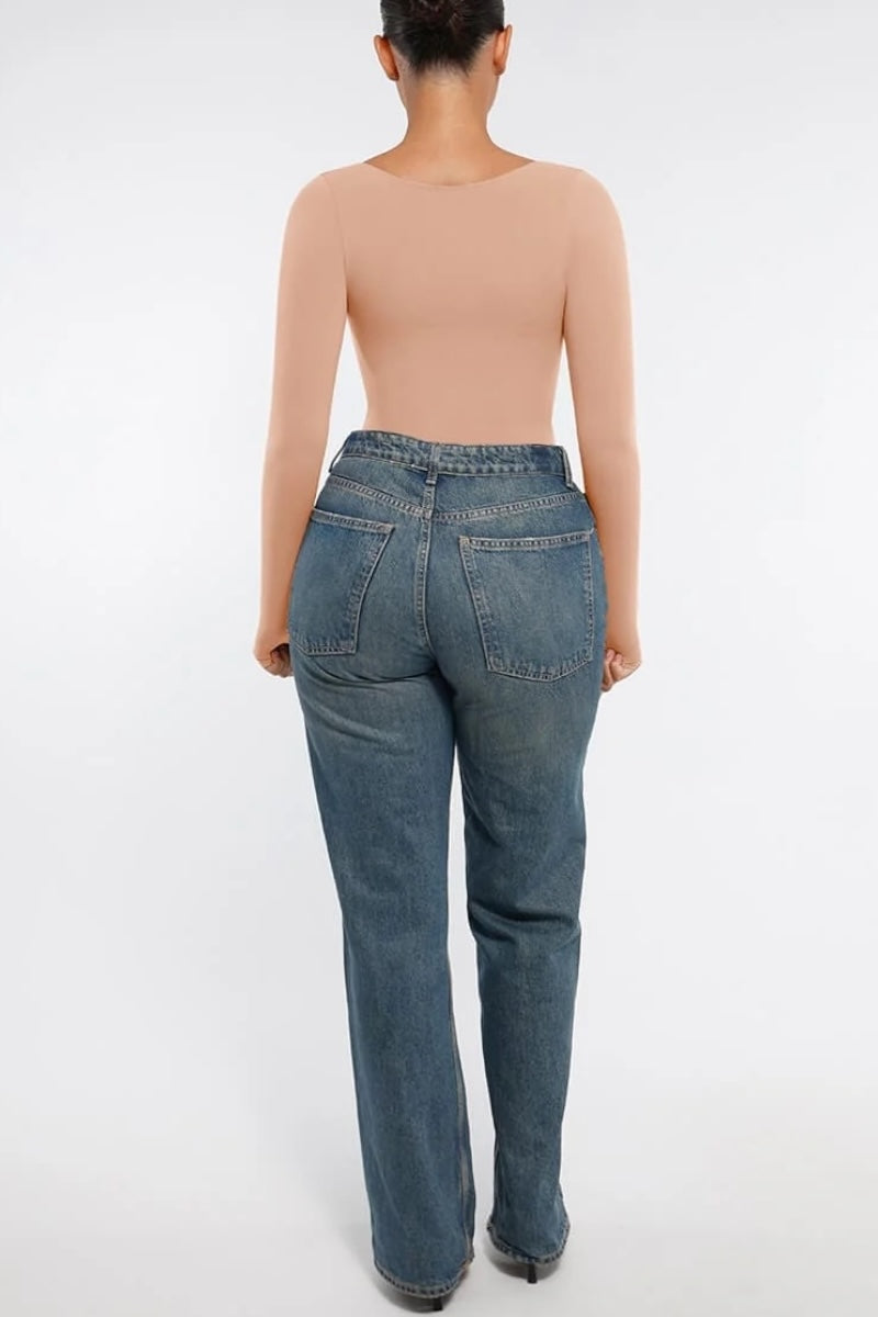 Person wearing blue jeans on a white background