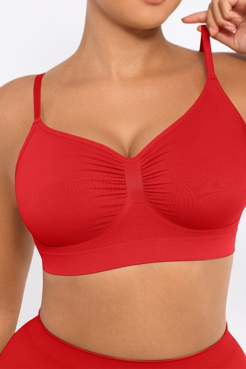 Red bralette worn by a person on a plain background