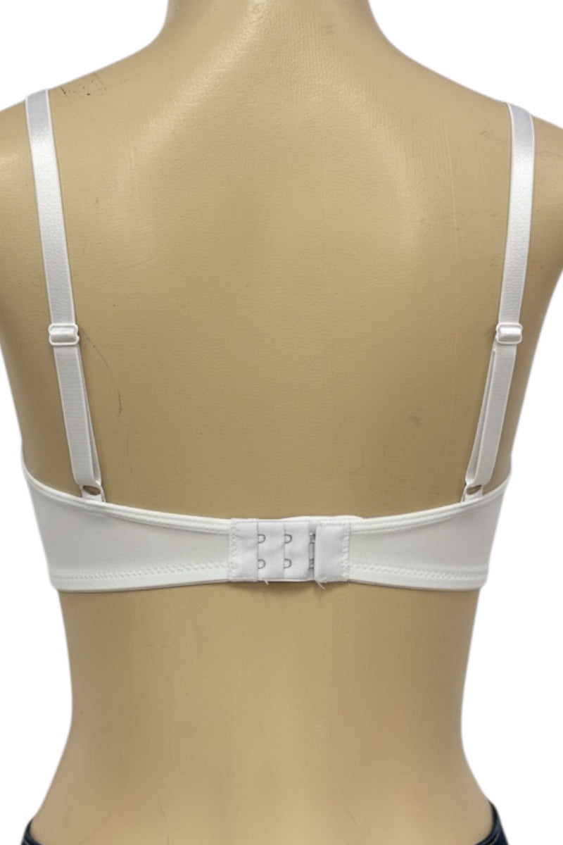 White bra on a mannequin with a beige background