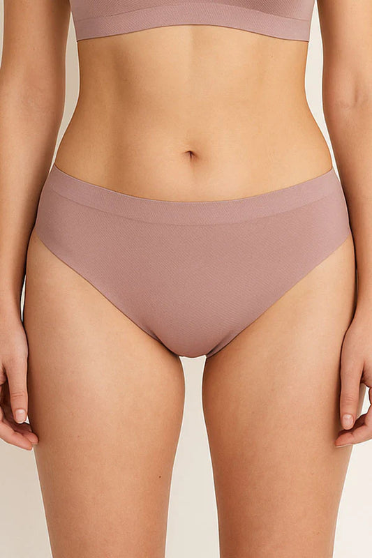 Person wearing a pair of mauve high-waisted bikini bottoms on a neutral background
