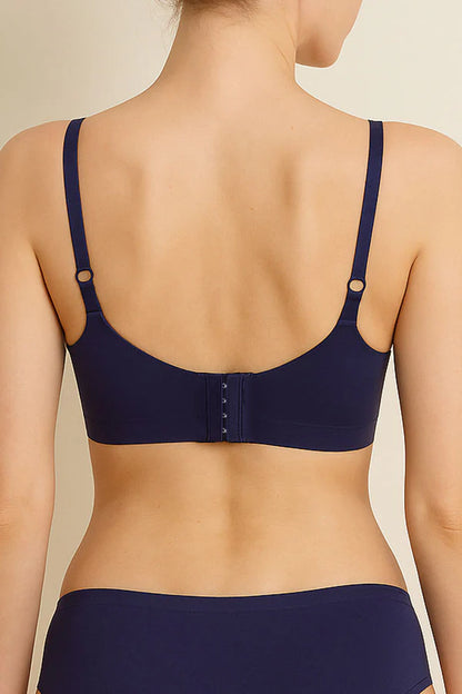 Navy blue bra worn by a person on a beige background