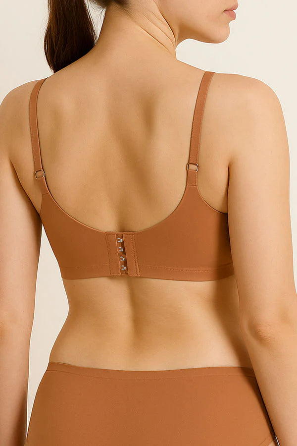 Tan bra worn by a model on a beige background