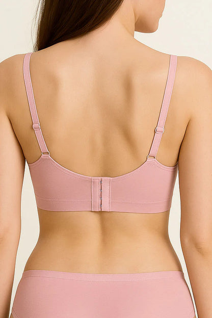 Pink bra and underwear set on a plain background