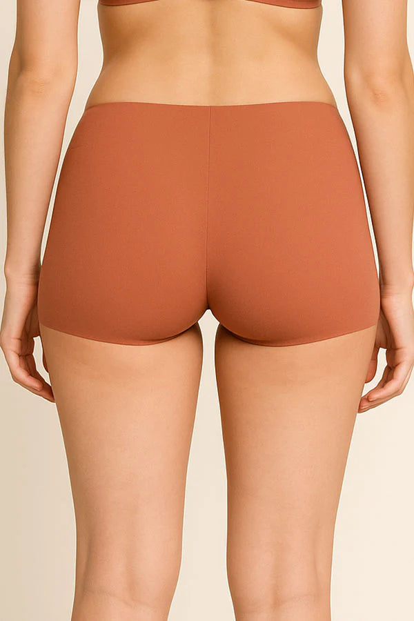 tan shorts worn by a person on a beige background