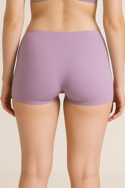 Person wearing a pair of lavender underwear on a beige background