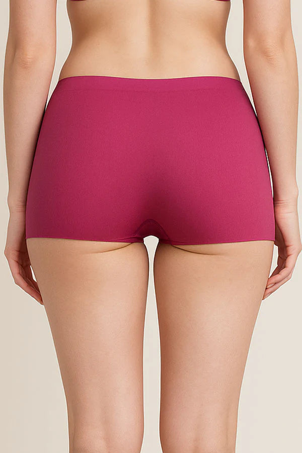 Person wearing a pair of Dark Fuchsia underwear on a beige background