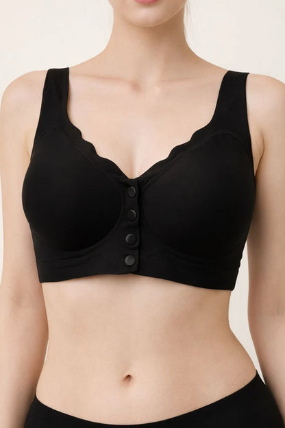 Black bra with button details on a beige background