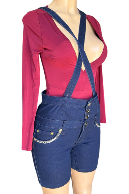 Mannequin wearing a red top and blue denim shorts with suspenders on a white background