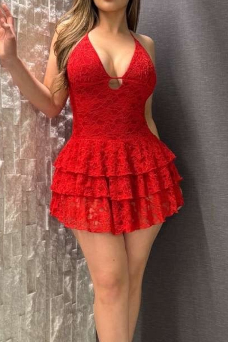 Red lace dress worn by a person against a textured gray background