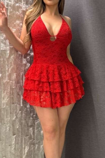 Red lace dress worn by a person against a textured gray background